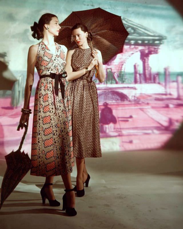 Dorian Leigh and Meg Mundy in print dresses by Traina-Norell, background painted by Eugene Berman, Vogue, March 15, 1947