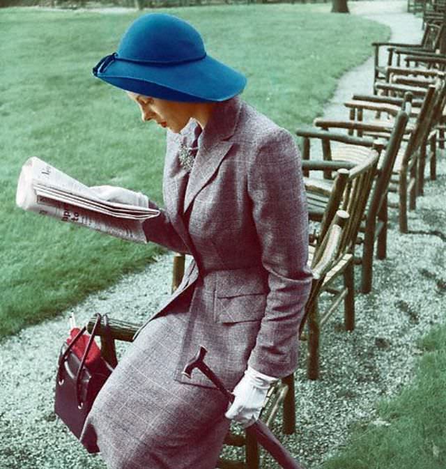 Meg Mundy is wearing grey muted plaid wool suit with teal blue hat, 1947