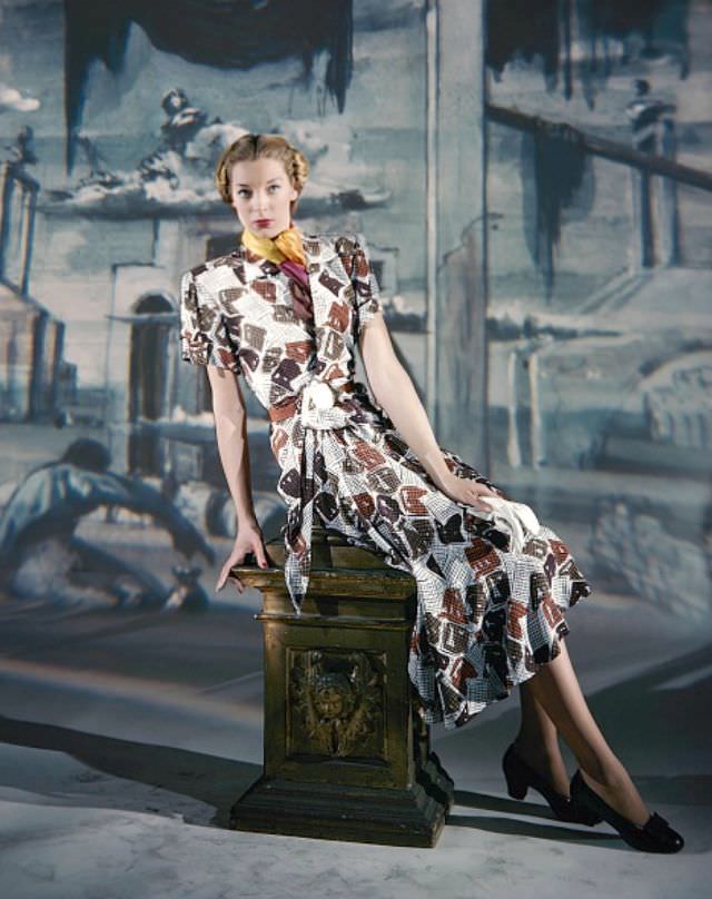 Model wearing short-sleeved print dress by Joseph Halpert, background painted by Eugene Berman, Vogue, March 15, 1947