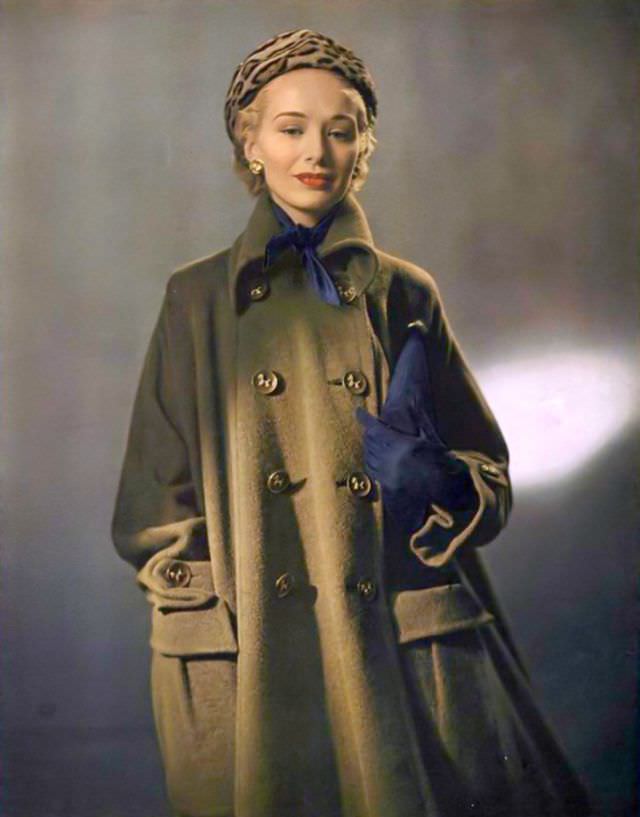 Ford model Sandra Nelson in wool-alpaca coat by Originala paired with winter navy accessories and ocelot hat, 1948