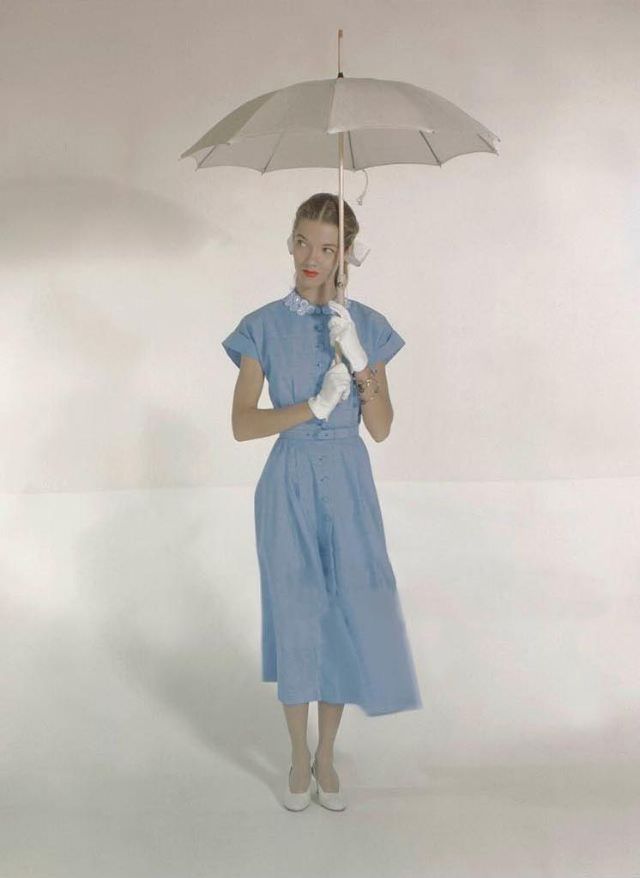 Model wearing dress with embroidered collar and cuffed sleeves by Nelly Don, gloves by Meyers, dyed linen shoes by Mademoiselle, and parasol by Town Umbrella Co., Glamour, 1948