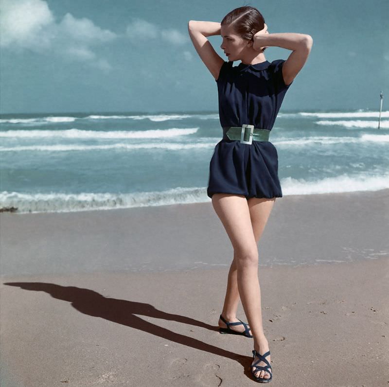 Model is wearing fisherman blue beach-suit with green belt by Carolyn Schnurer, 1945