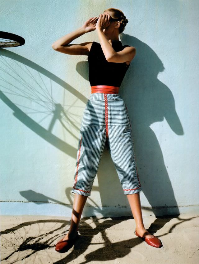 Model is wearing mattress ticking capri pants with red trim together with sleeveless turtleneck from Hi-Dee, Vogue, April 1945