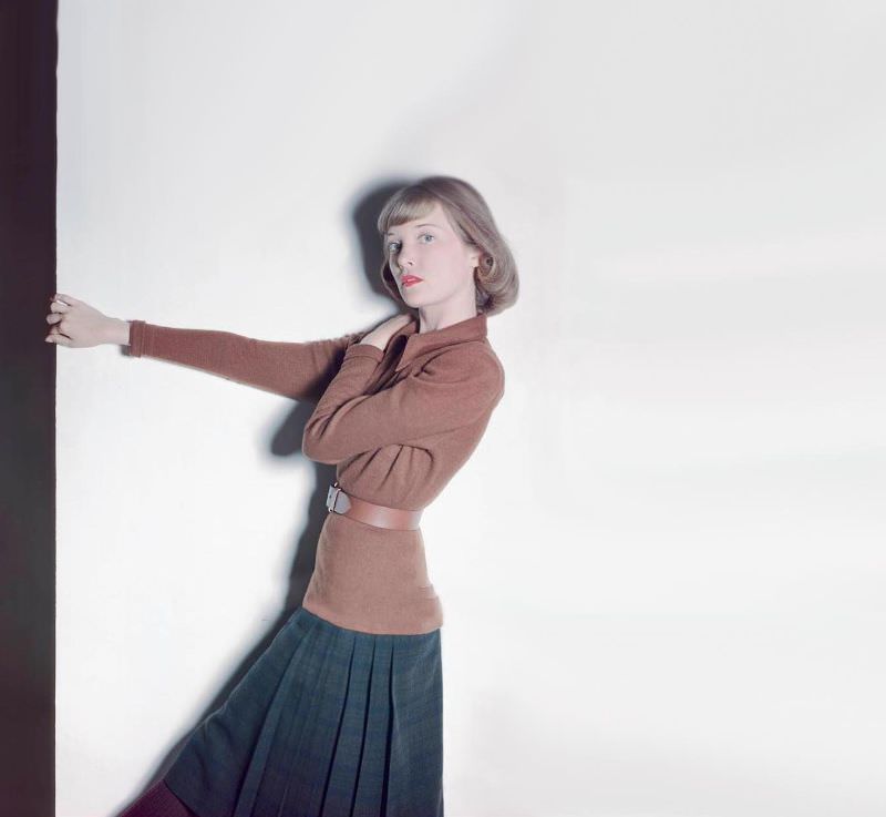 Charlotte Payne in long brown jersey blouse, Farnsworth Black Watch plaid skirt, both by Tilly Schanzer, Glamour, 1946
