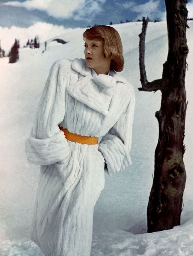 Charlotte Payne wearing white trench coat of Russian ermine from Reine, 1946