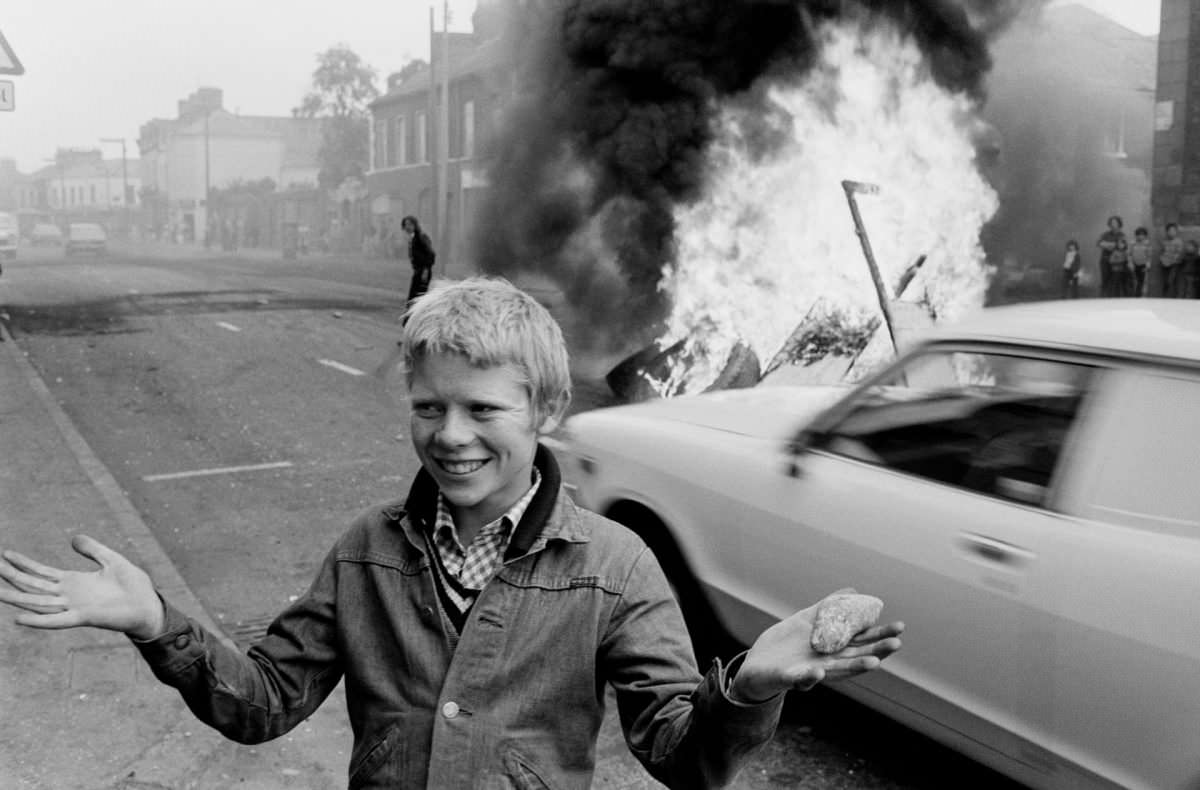Youth with a stone during a riot at the top of Leeson Street, west Belfast, 1978