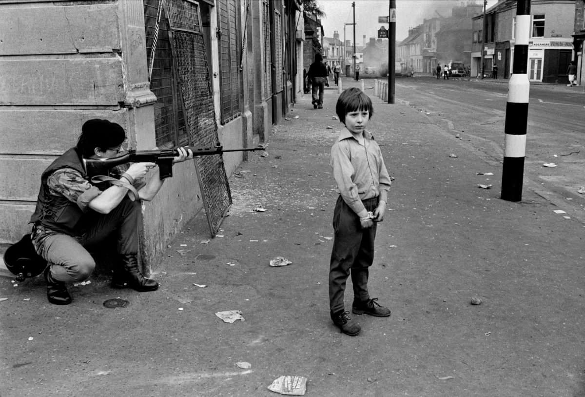 Soldier pointing rifle, bottom of Clonard Street, Belfast, 1978