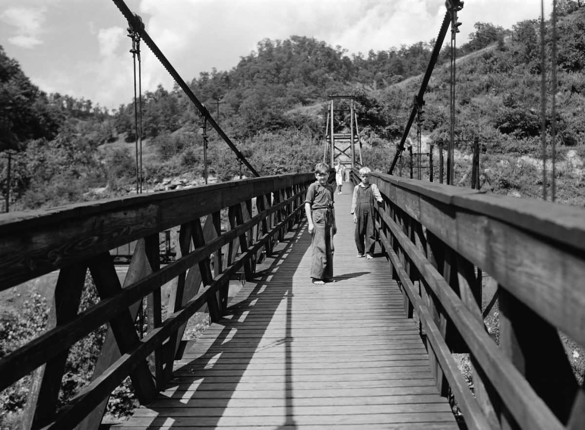 Children cross a swing bridge, Hazard, Kentucky, 1940.
