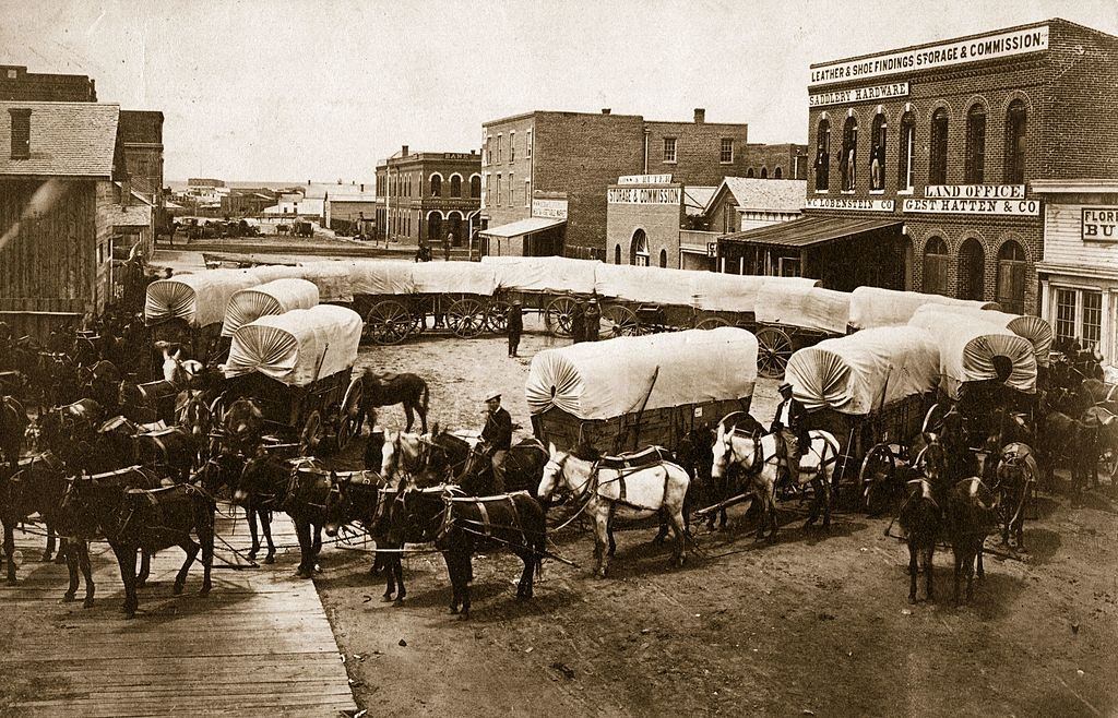 A convoy of covered wagons congregate in Denver, 1863.