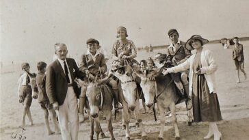 people enjoying donkey rides on the beach