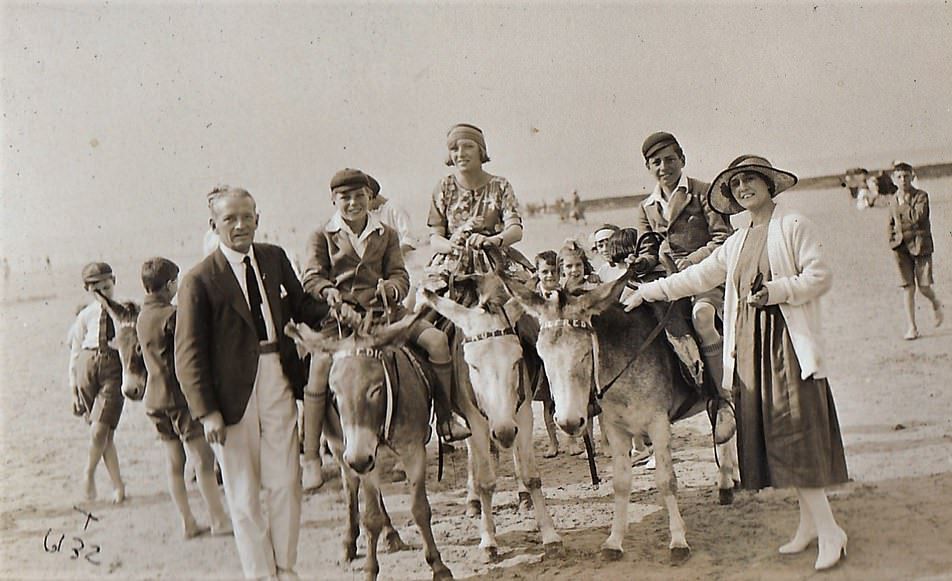 people enjoying donkey rides on the beach