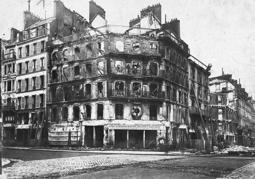 A corner building in Paris shows burn damage inflicted by Prussian occupation troops after the surrender of France in the Franco-Prussian War.