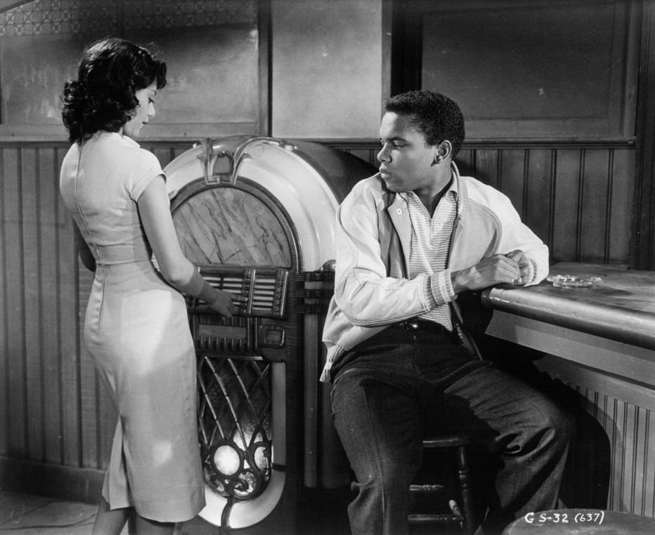 Ruby Dee with Johnny Nash at the juke box in a scene from the film 'Take A Giant Step', 1959.