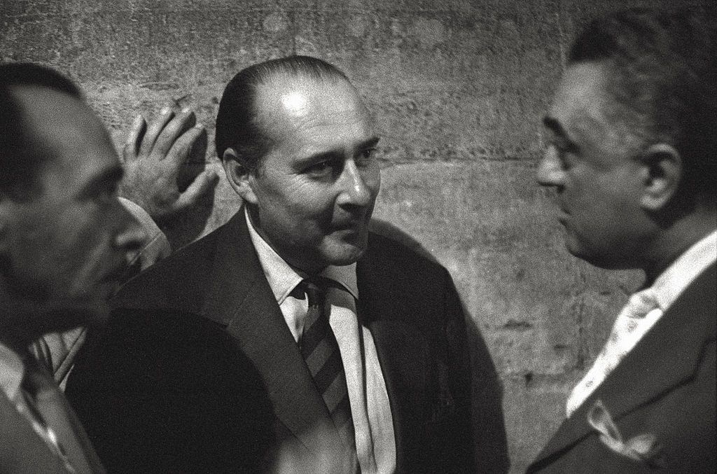 The director Roberto Rossellini making conversation in a social event in the course of the 17th Venice Intenational Film Festival.