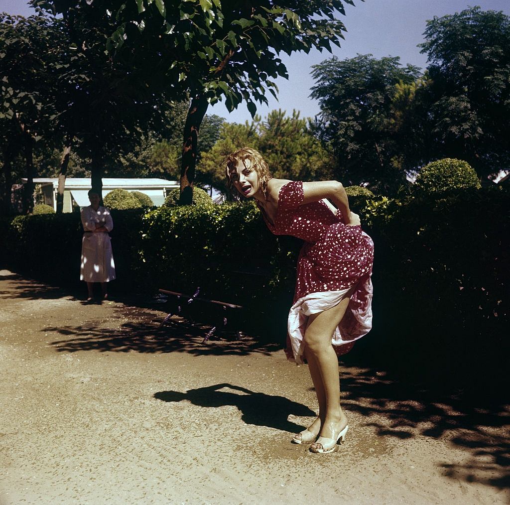 Italian actress and TV presenter Sandra Milo (Salvatrice Elena Greco) posing in a wet dress.