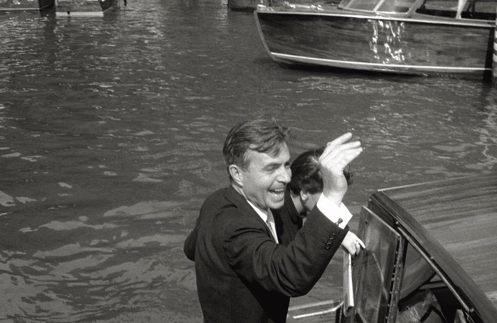 The actor James Mason greets his admirers from the boat that is leading him to Lido, in Venice, during the 17th Venice Intenational Film Festival.