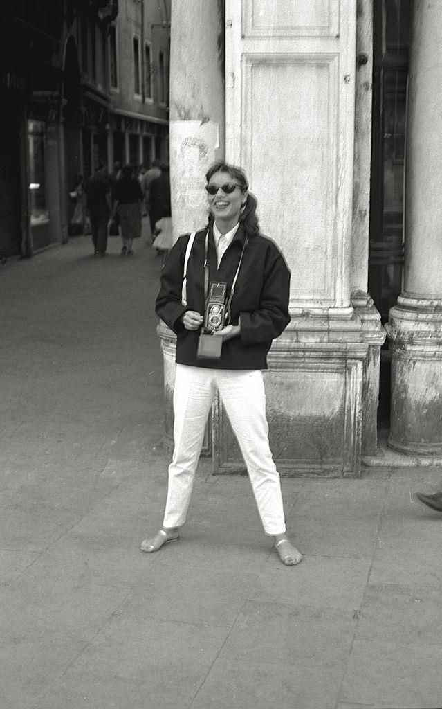 The actress Elsa Martinelli going for a walk in Venice, with sunglasses and camera, during the 17th Venice Intenational Film Festival.