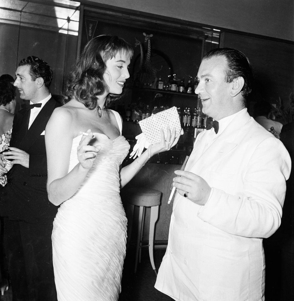 Italian actress Elsa Martinelli speaking with Bernard McElwaine Sunday Pictorial Journalist, at 1956 Venice Film Festival, Italy.