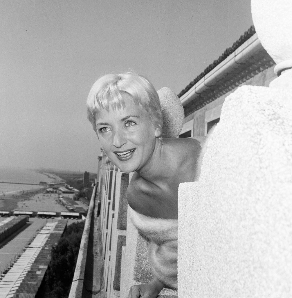 Italian TV star Elena Guisti, wearing a fur wrap at 1956 Venice Film Festival.