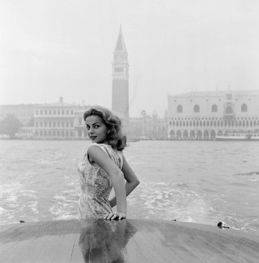 Abbe Lane, American singer and actress, enjoys a motorboat ride along the Grand Canal