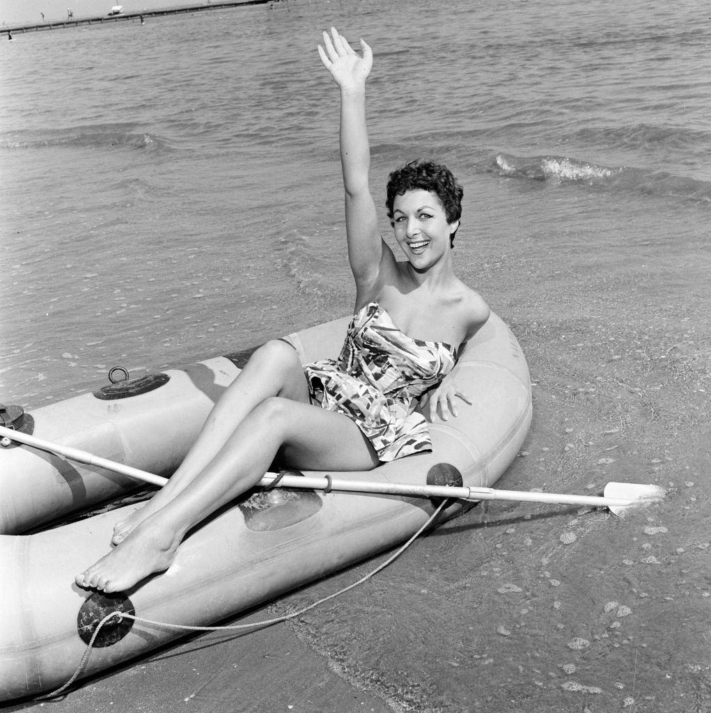 Italian actress Sophia Devitri poses for pictures on a rubber dingy at 1956 Venice Film Festival.