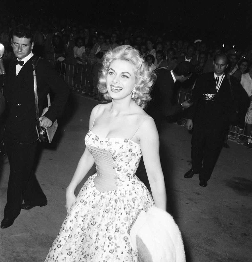 Italian actress Sandra Milo arrives at the Casino, applauded by fans and a member of the Italian navy. Venice Film Festival, Friday 31st August 1956