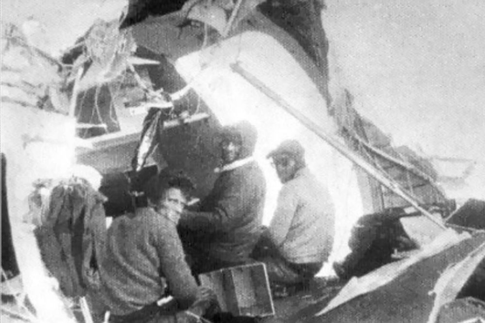 Survivors of Flight 571 outside of the plane's wreckage.
