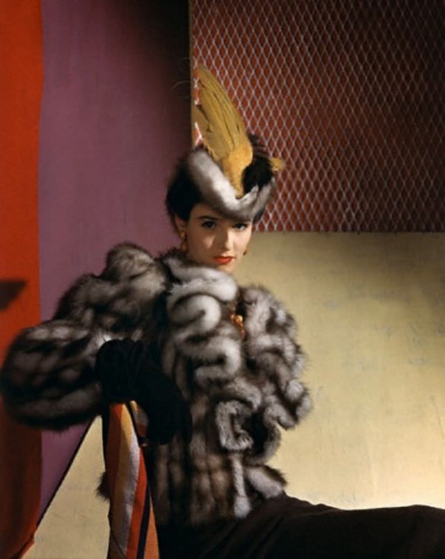 Babe Paley is wearing a be-winged marten hat and jabot revers on a natural marten hat by John Frederics, 1939