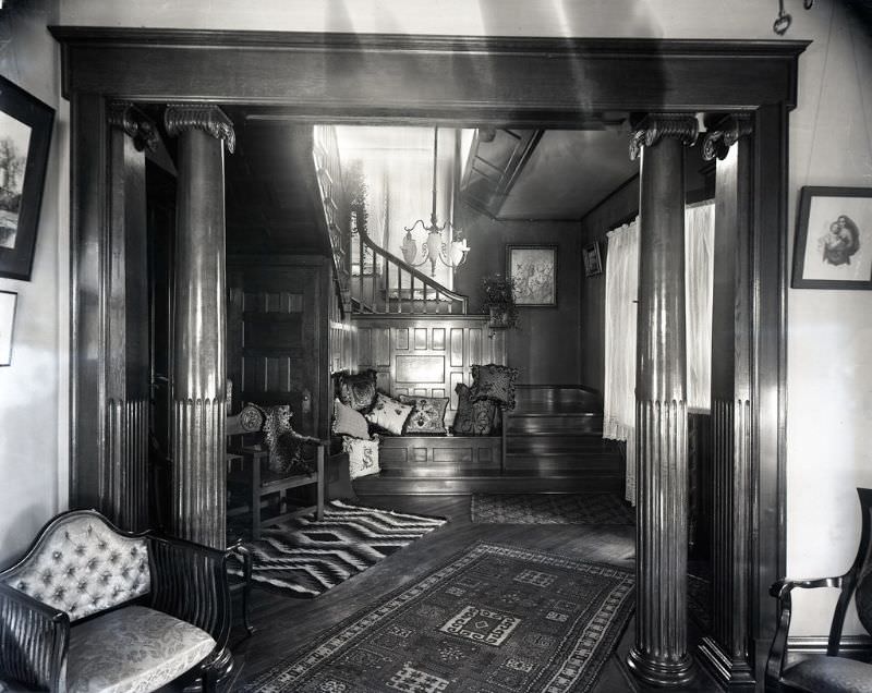 With the camera stationed in the front room, Coover has photographed the hallway of the Shambaugh house, the focus being its built-in seat covered with pillows, 1892