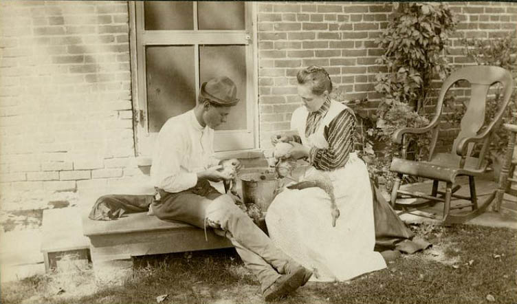 Katherine Horack and her son, H. Claude Horack, sit on the back steps of their home, cleaning ducks that were presumably caught by H. Claude, 1895-1897