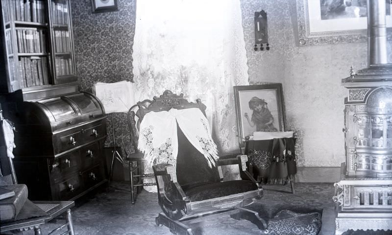 A view of the parlor with the Splendid stove to the right and the roll top desk to the left.