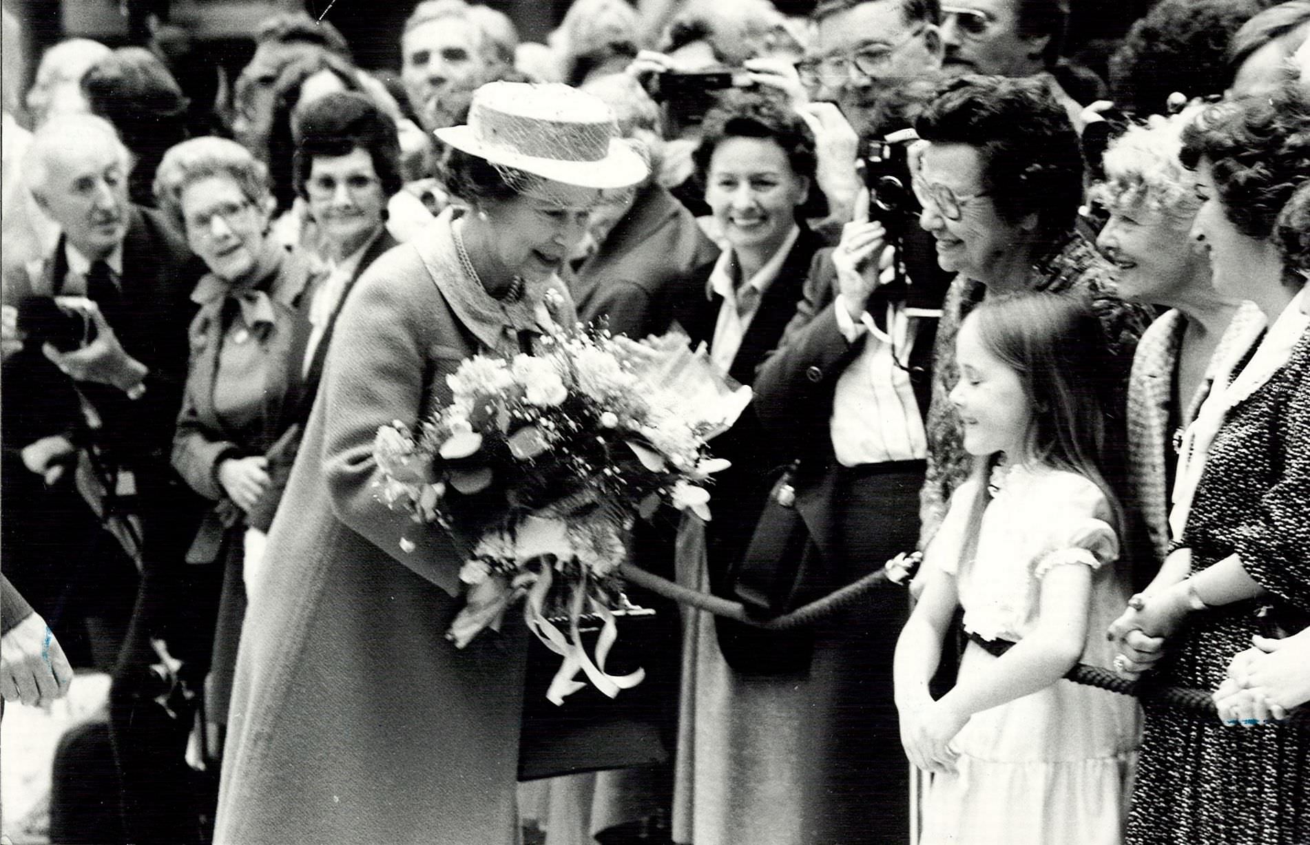 The Queen receiving flowers from the crowd at the opening of Birmingham International Airport, 20th May 1984.