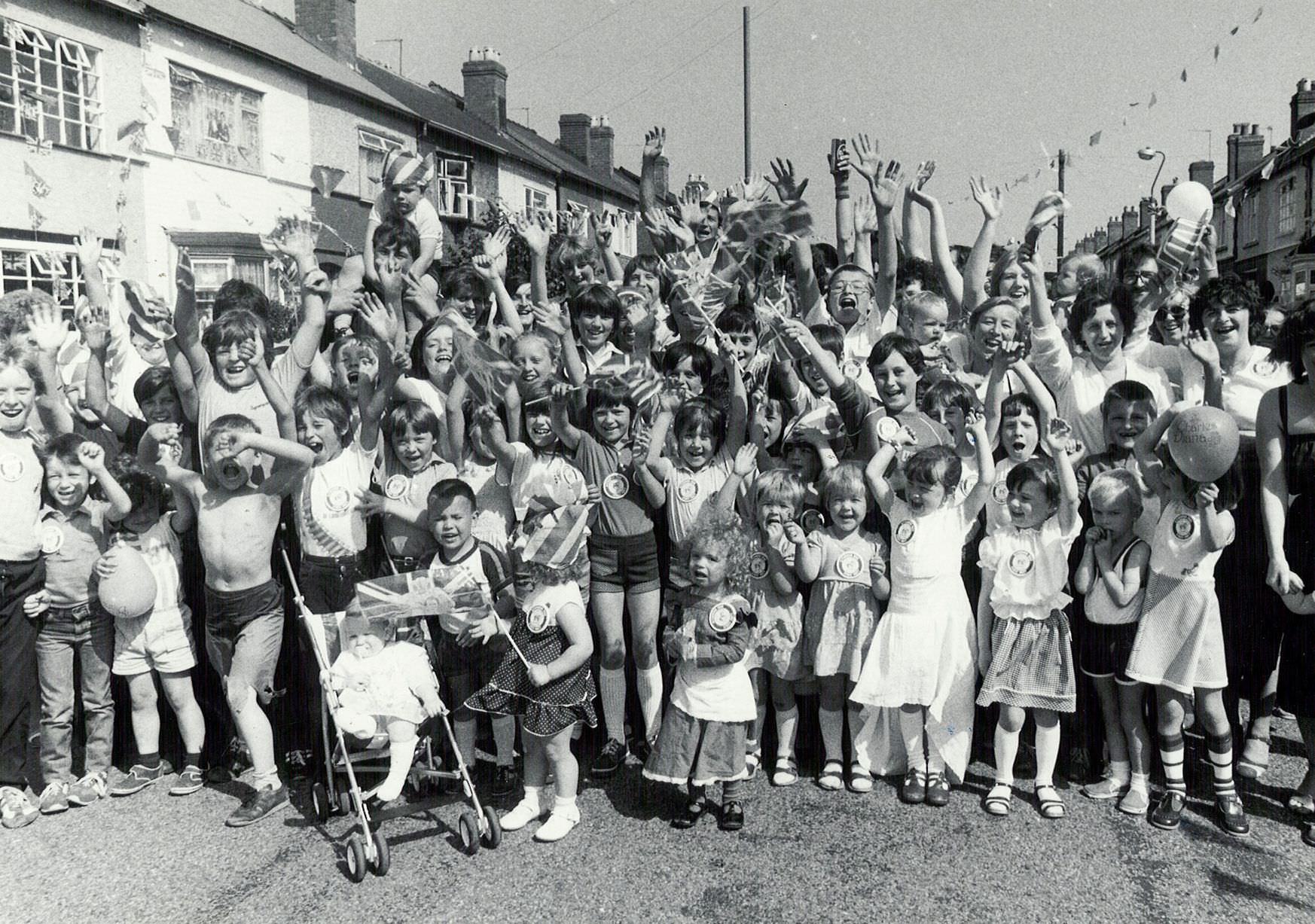 Street party for the Royal Wedding of Prince Charles and Lady Diana Spencer at Blythswood Road in Tyseley who set up a rousing cheer as their party got underway. 29th July 1981.