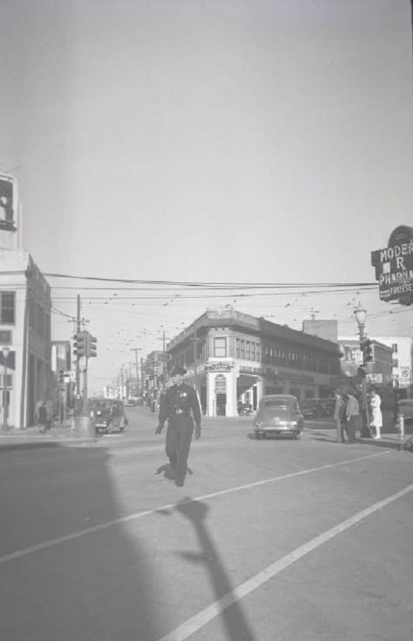 Policeman crossing street. Intersection of Pacific, N. St. Paul, and Live Oak, 1902