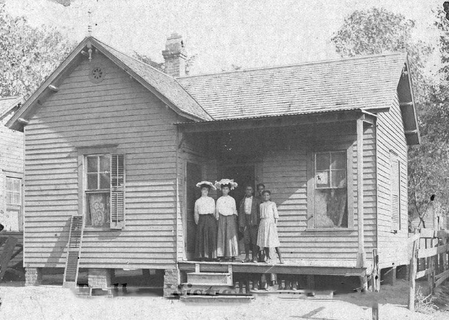 Two ladies and three teens on the front porch of a house, 1906
