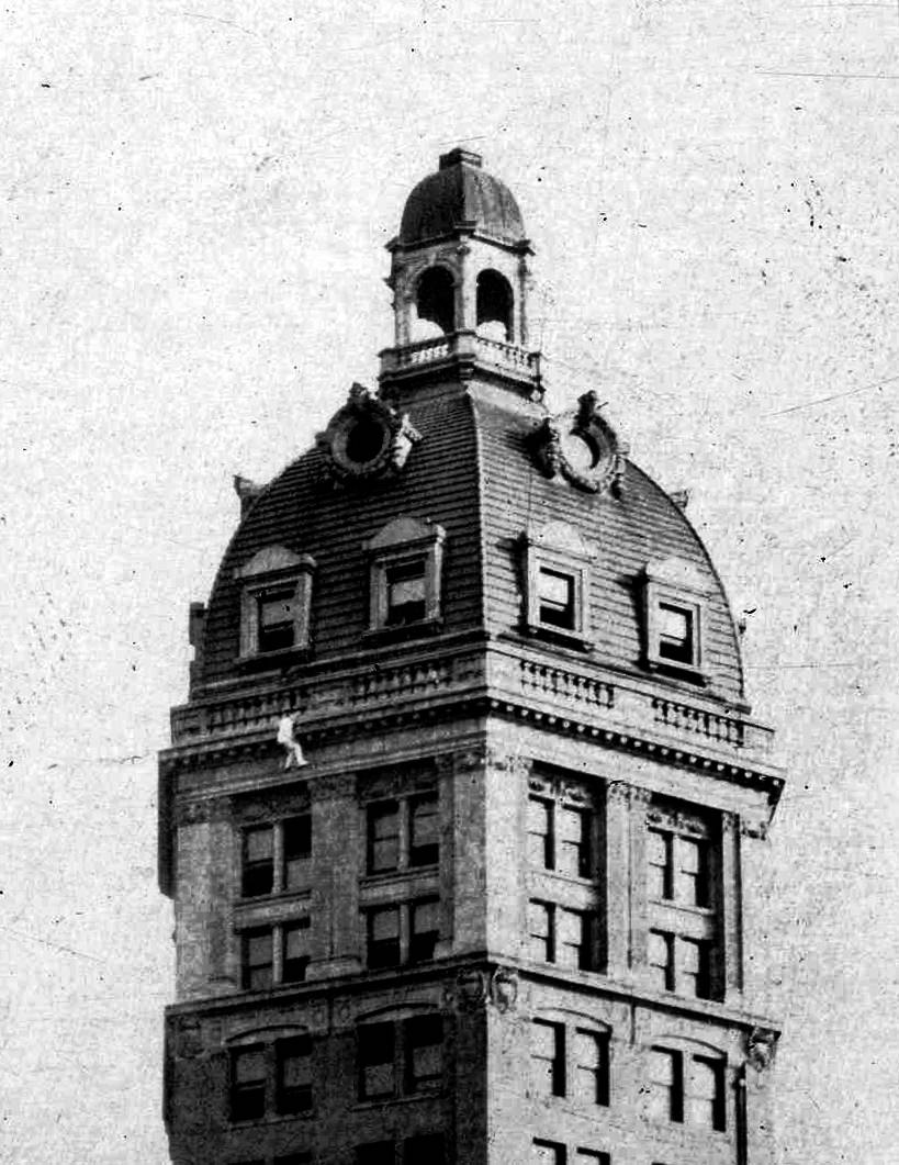 The “Human Fly” climbing the World Tower on the corner of Beatty and West Pender in Vancouver, 1918.