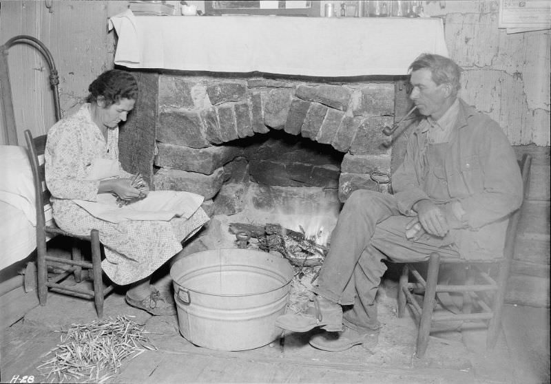 Mr. J. W. Melton and his wife by the fireplace getting ready for supper.