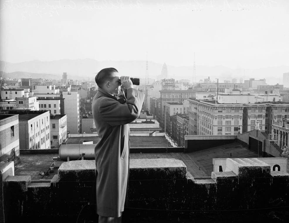 Thomas A Dobbie, Junior (Air Pollution Control inspector looks over horizon for violators). Smog control in downtown Los Angeles, 7 December 1948.