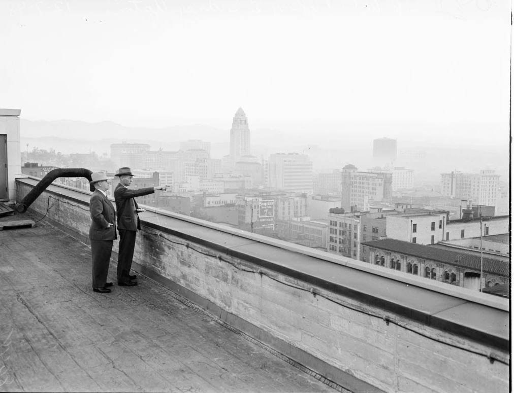 Thomas A Dobbie, Junior (Air Pollution Control inspector looks over horizon for violators) and W.C Tiffany (Maintenance Foreman, Pacific Telephone & Telegraph Company), 1948