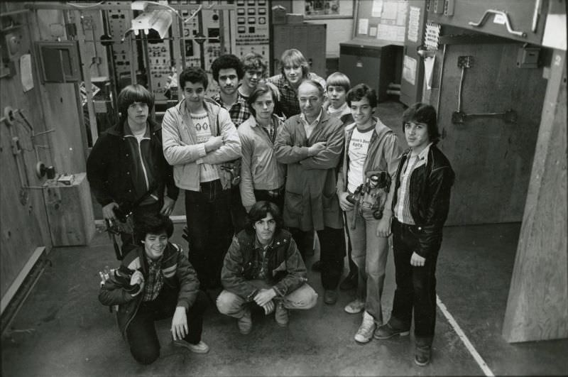Students and teacher posing in mechanical room