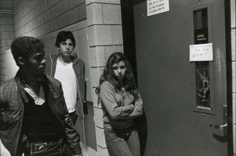 Three students standing outside photography room