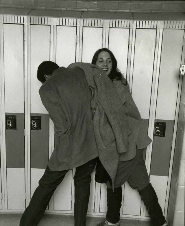Two students clowning by the hall lockers