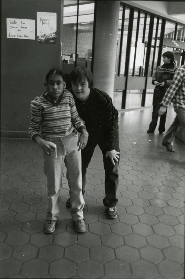 Two students posing in school hallway