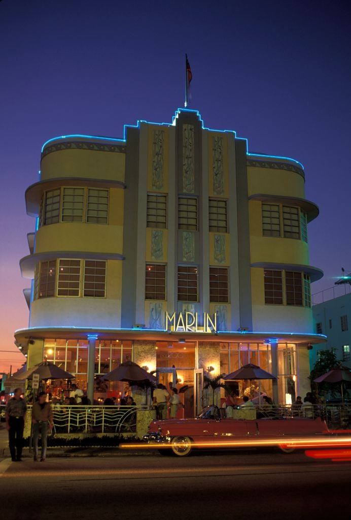 The Marlin Hotel and a vintage Cadillac convertible at kerbside on South Beach, Miami, 1990.