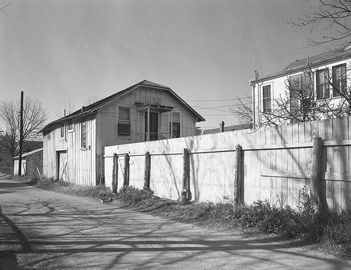 Fence and garage and garage apartment in 200 block of Culberson Alley, 1965