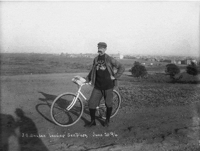 J.O. Snyder standing with a bicycle on the outskirts of San Diego, 1896
