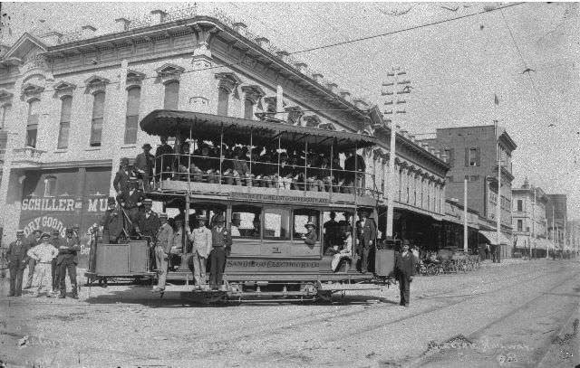 People seated on a double-decker San Diego Electric Railway streetcar at Fifth and Market Street, 1892