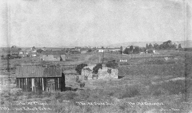 View of Old Town's adobe chapel, Don Rafael's cabin, stone jail, and graveyard, 1895