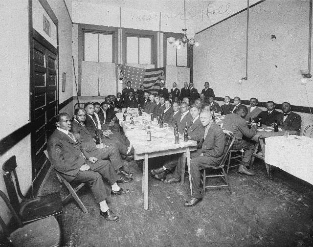 Group of African American men seated at tables in a Masonic Hall, 1895