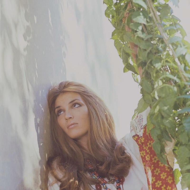 Talitha Getty leaning on a wall with vines by her house in Marrakesh, Morocco, January 15, 1970
